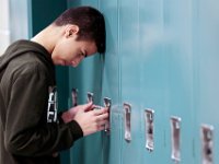 Grandiel Hernandez uses all of his will power to get his lock to work at the Roosevelt Middle School in New Bedford.   [ PETER PEREIRA/THE STANDARD-TIMES/SCMG ]